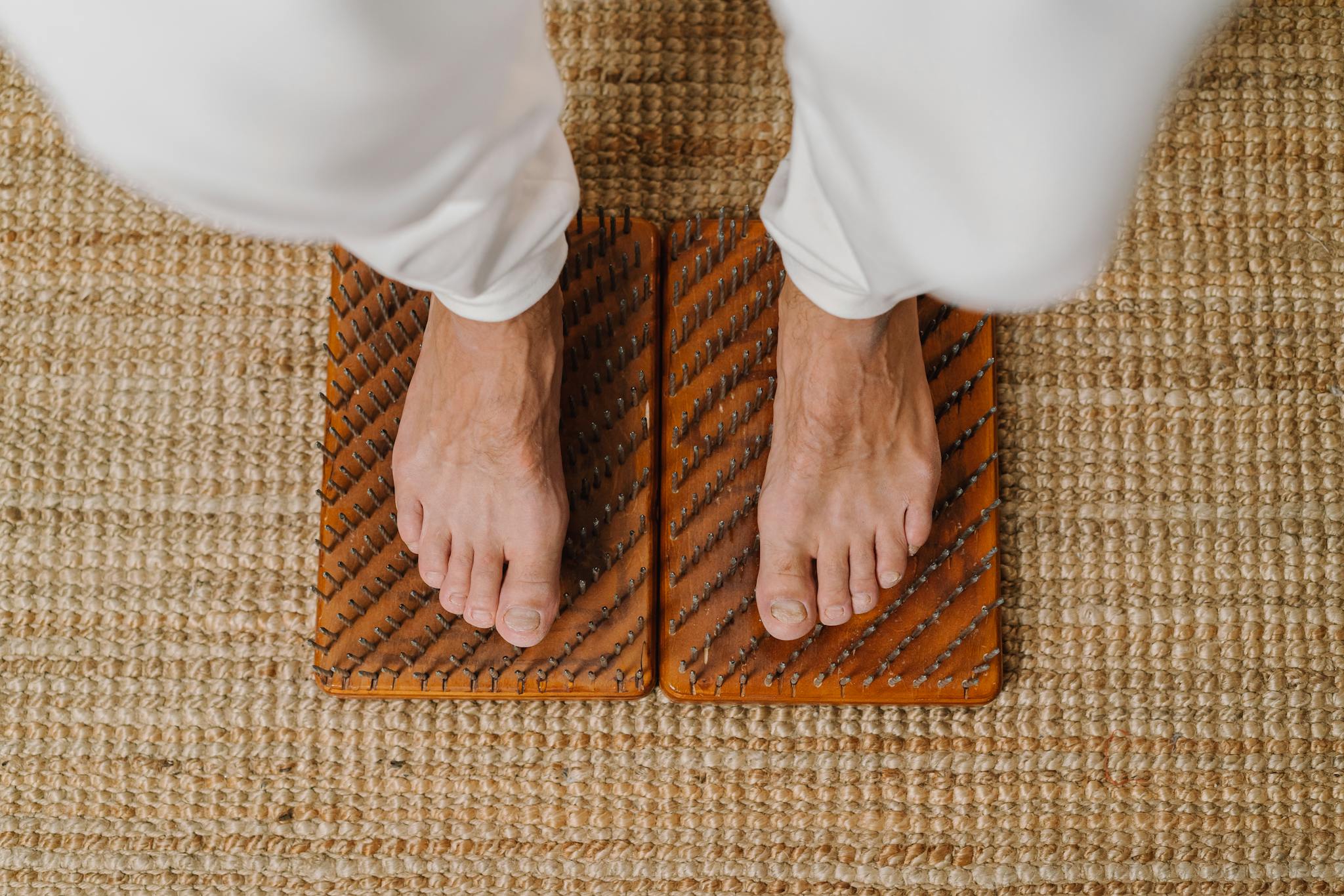 Close-up of feet on an acupressure board for holistic wellness practice.